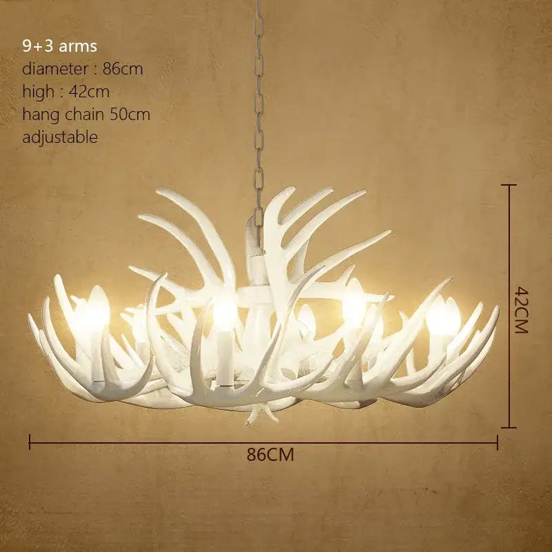 White decorbites antler chandelier with nine arms and three decorative branches suspended by a sleek metallic chain