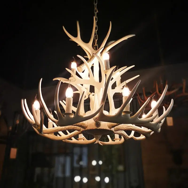 Decorbites antler chandelier with illuminated candle-style bulbs in cream resin resembling natural deer horns for home and hotel use