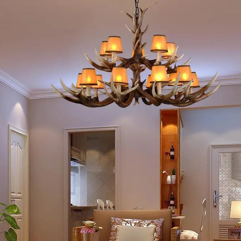 Decorbites antler chandelier with warm amber lampshades and rustic dark brown resin finish for modern living room lighting