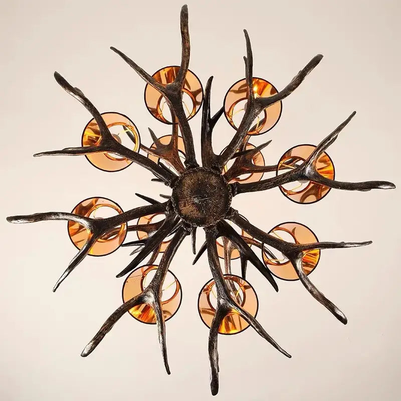 DecorBites antler chandelier with dark textured metal arms and amber glass shades for modern rustic living rooms