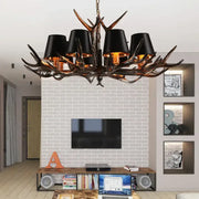 DecorBites antler chandelier with black lampshades and dark rustic resin finish for vintage art deco decor
