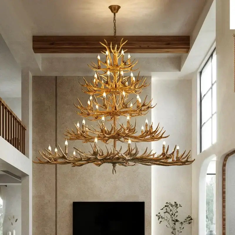 Golden antler deer chandelier with multiple tiers and candle bulbs made of rustic resin by DecorBites antler deer