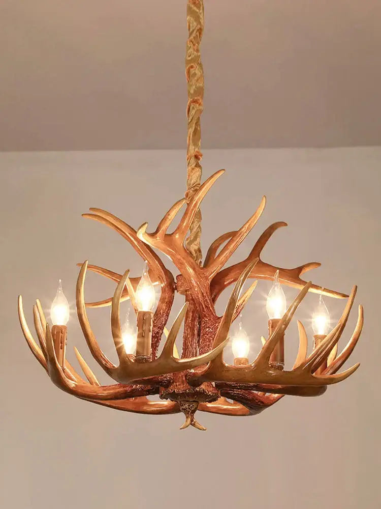 Golden six-arm antler pendant chandelier with lit candle-style bulbs for living room decor by decorbites antler pendant