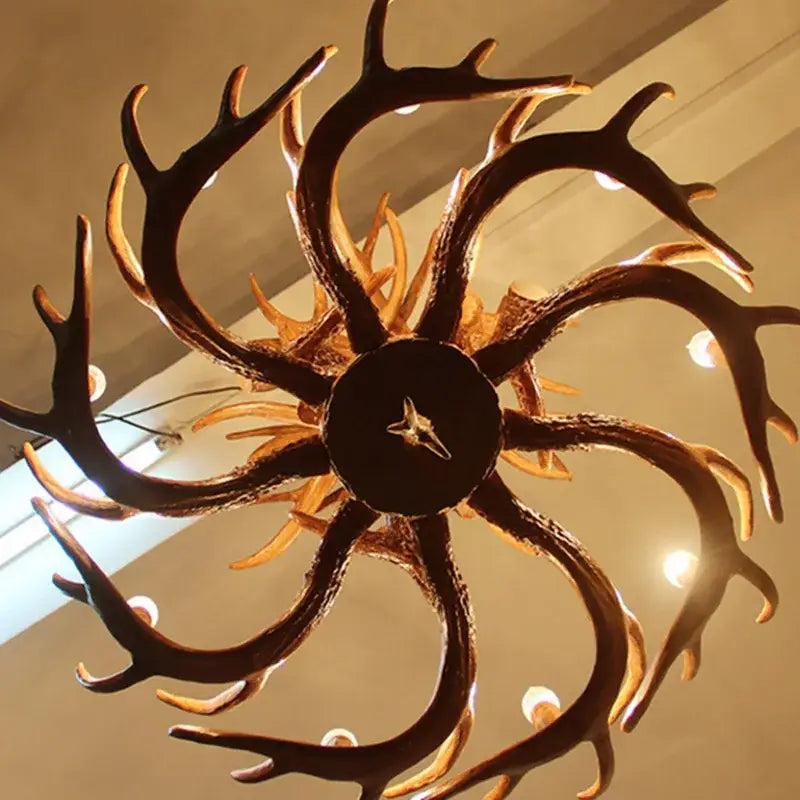 DecorBites antler pendant chandelier with dark rustic finish and warm golden accents for living room decor