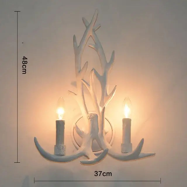 White antler-themed wall sconce with two candle-style lights for living room decor by DecorBites antler pendant