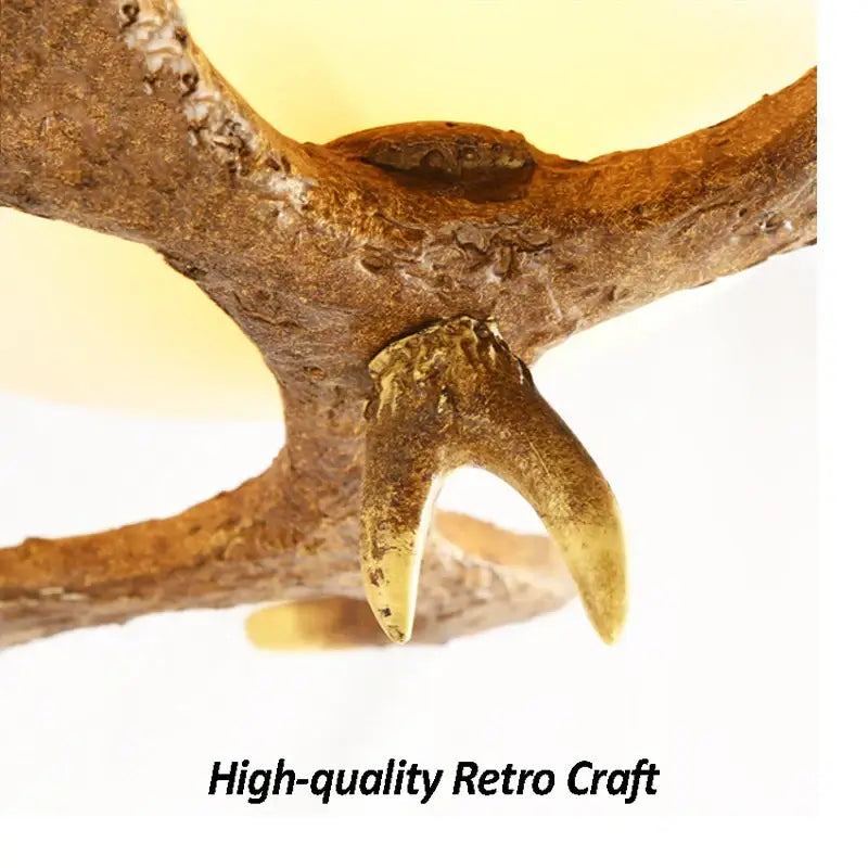 Natural brown antler with polished golden-tipped tine in decorbites antler resin glass ceiling light for home decor