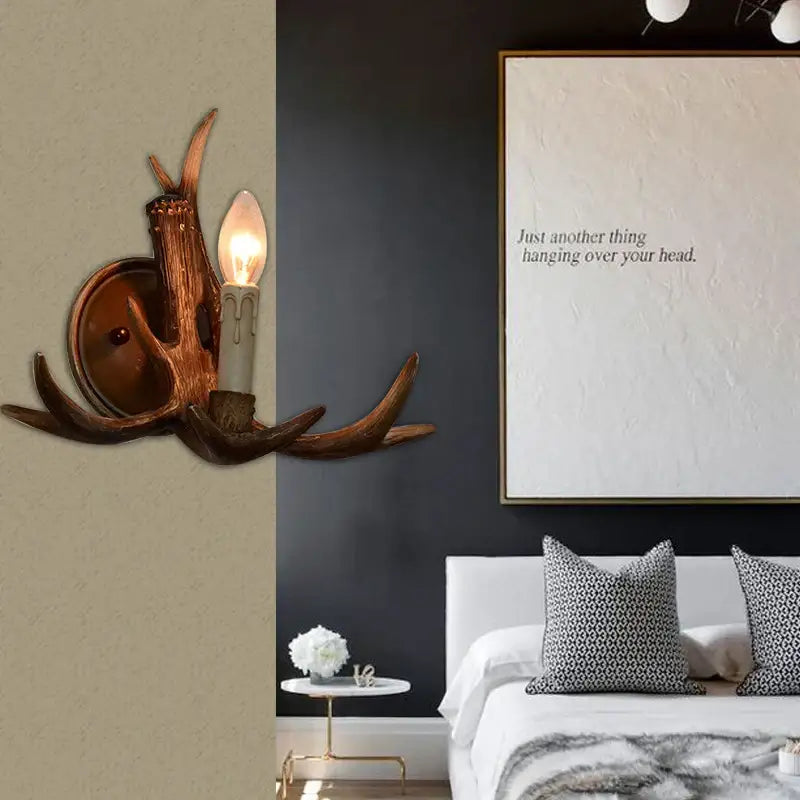 Decorbites antler resin wall lamp with warm rustic finish and candle-style bulb for living room corridor or bar lighting