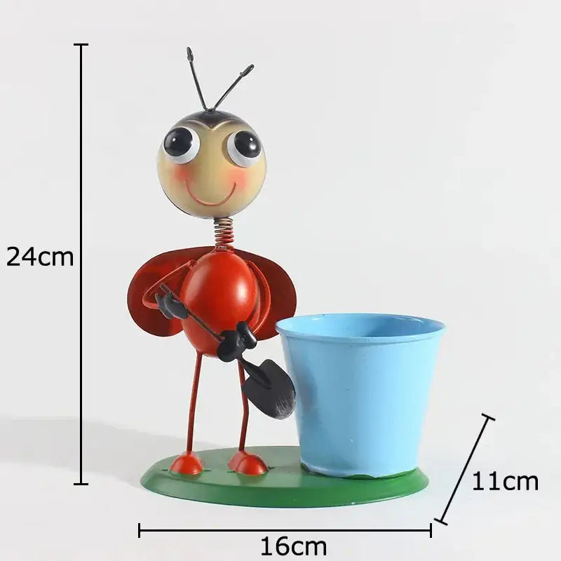 Decorbites ants gardener vase featuring a red and yellow metal ladybug figurine holding a shovel by a light blue pot