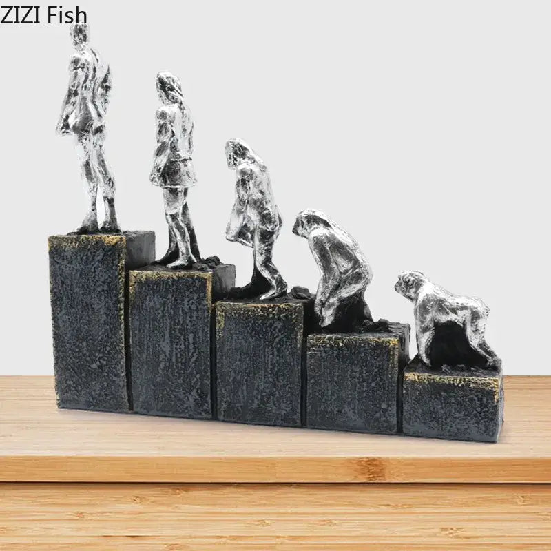 Silver resin decorbites ape man evolution sculpture set on tiered black bases depicting man evolution stages