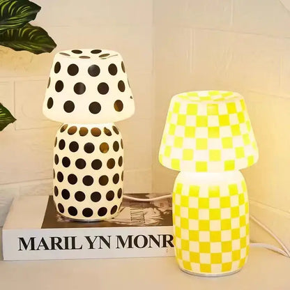 Two decorative table lamps including a white polka dot and bright yellow checkered decorbites apollo mushroom glass model