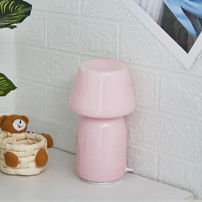A sleek glossy pink ceramic table lamp with a mushroom-shaped design decorbites apollo mushroom glass bedside light