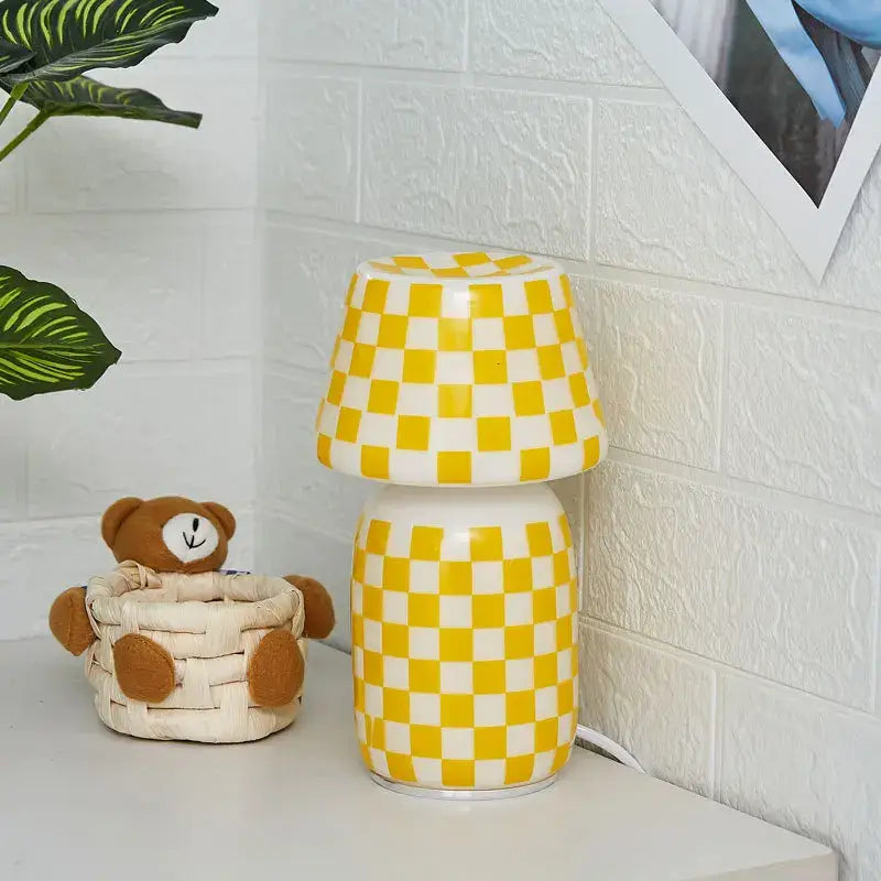 A charming yellow and white checkered ceramic table lamp with rounded base and shade in the decorbites apollo mushroom glass style