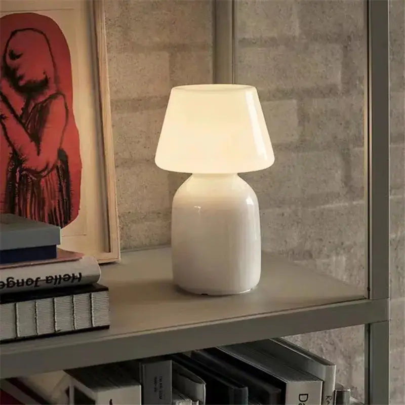 A sleek white ceramic table lamp with a rounded base and conical shade from decorbites apollo mushroom glass collection