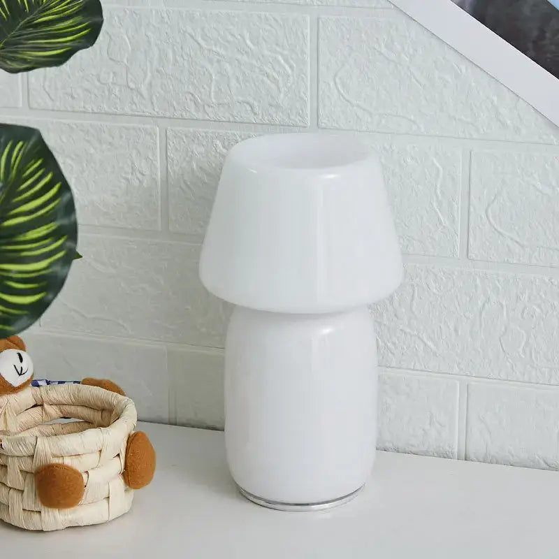 A sleek white ceramic table lamp with a glossy finish and rounded mushroom shape from decorbites apollo mushroom glass collection
