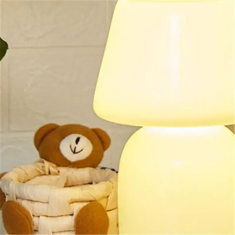 Decorbites apollo mushroom table lamp with a warm yellow glow and smooth white glass bedside night light shade