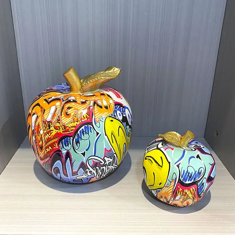 Vibrant decorbites apple figurines featuring graffiti-painted designs with golden stems for home office decor