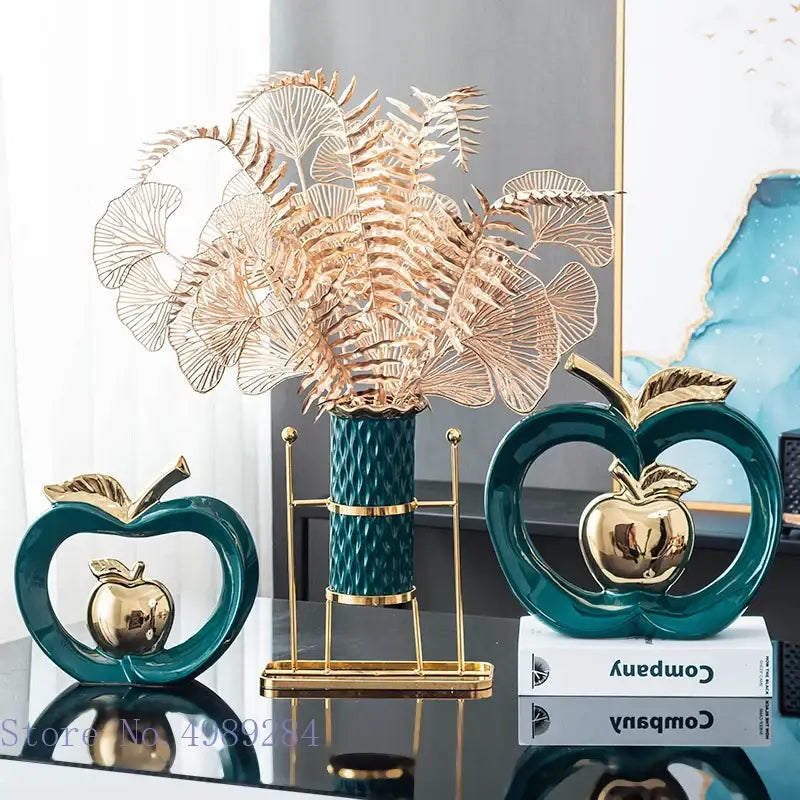Teal ceramic decorbites apple hollow sculptures with gold metallic interiors and stems framed by heart-shaped outlines