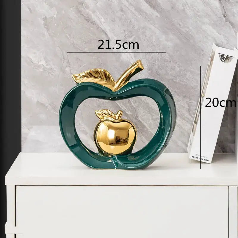Glossy teal ceramic decorbites apple hollow candy jar featuring gold leaf stem and inner golden apple replica for home decor