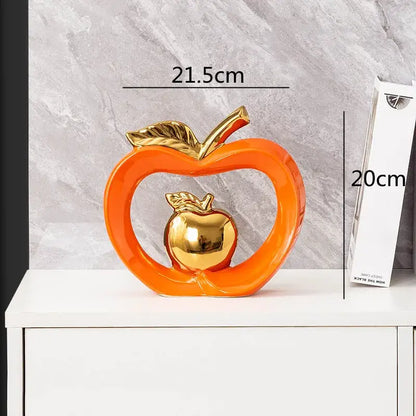 Vibrant orange DecorBites apple hollow ceramic candy jar with polished gold inner apple and leaf accents for home decor