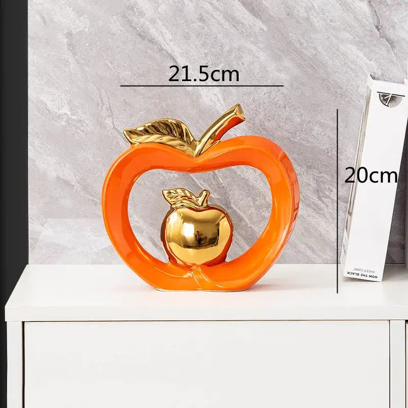 Vibrant orange DecorBites apple hollow ceramic candy jar with polished gold inner apple and leaf accents for home decor