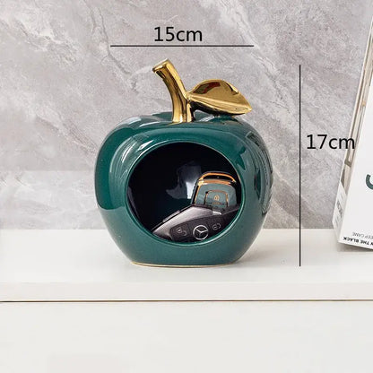 Glossy teal ceramic decorbites apple hollow key holder with gold-toned stem and open center for keys display