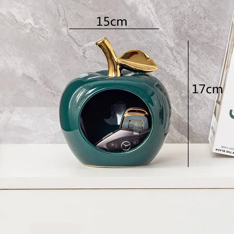 Glossy teal ceramic decorbites apple hollow key holder with gold-toned stem and open center for keys display