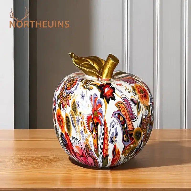 A vibrant decorbites apple resin figure ornament with intricate patterns, glossy finish, and golden stem for decor
