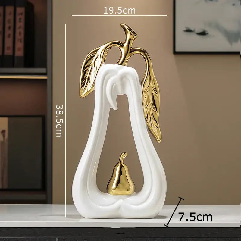 Decorbites apple sculpture white ceramic pear-shaped ornament with gold leaf accents and a gold ceramic pear inside