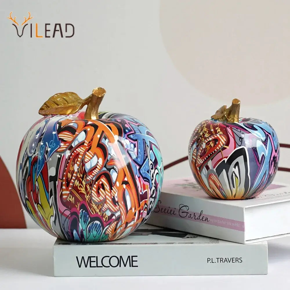 DecorBites apple sculpture resin ornament with vibrant graffiti paint and golden leaf stems for modern interior decor