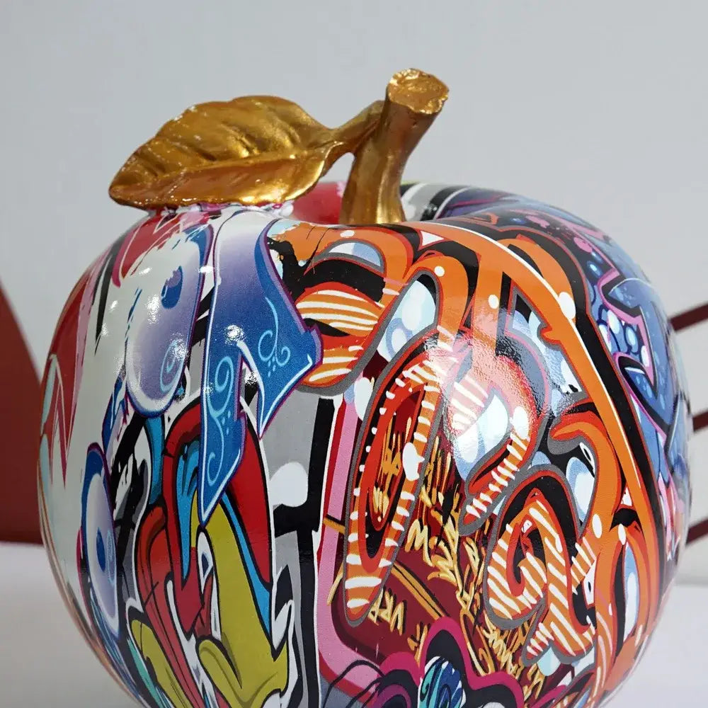 DecorBites apple sculpture resin ornament featuring vibrant graffiti design, glossy finish, and golden leaf stem