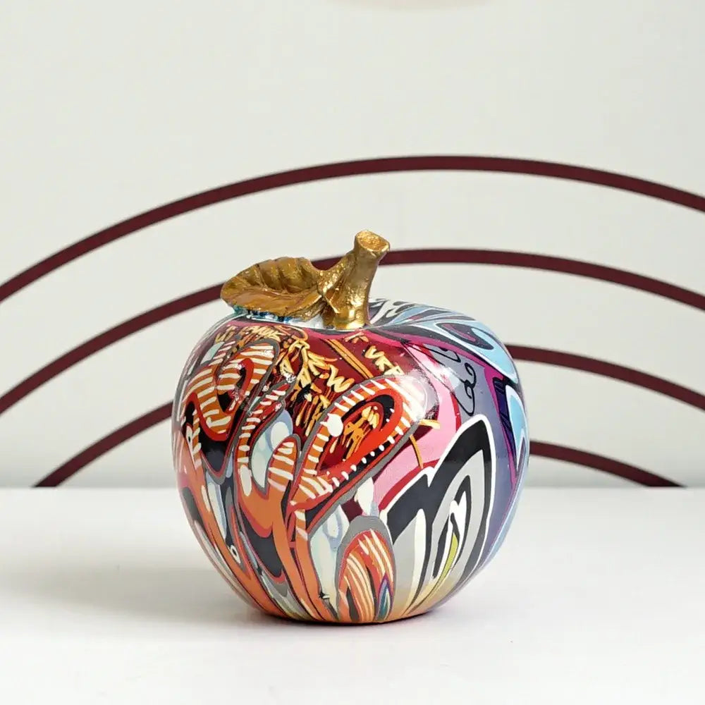 DecorBites apple sculpture resin ornament with vibrant graffiti-style reds, oranges, blues, and golden stem for modern decor