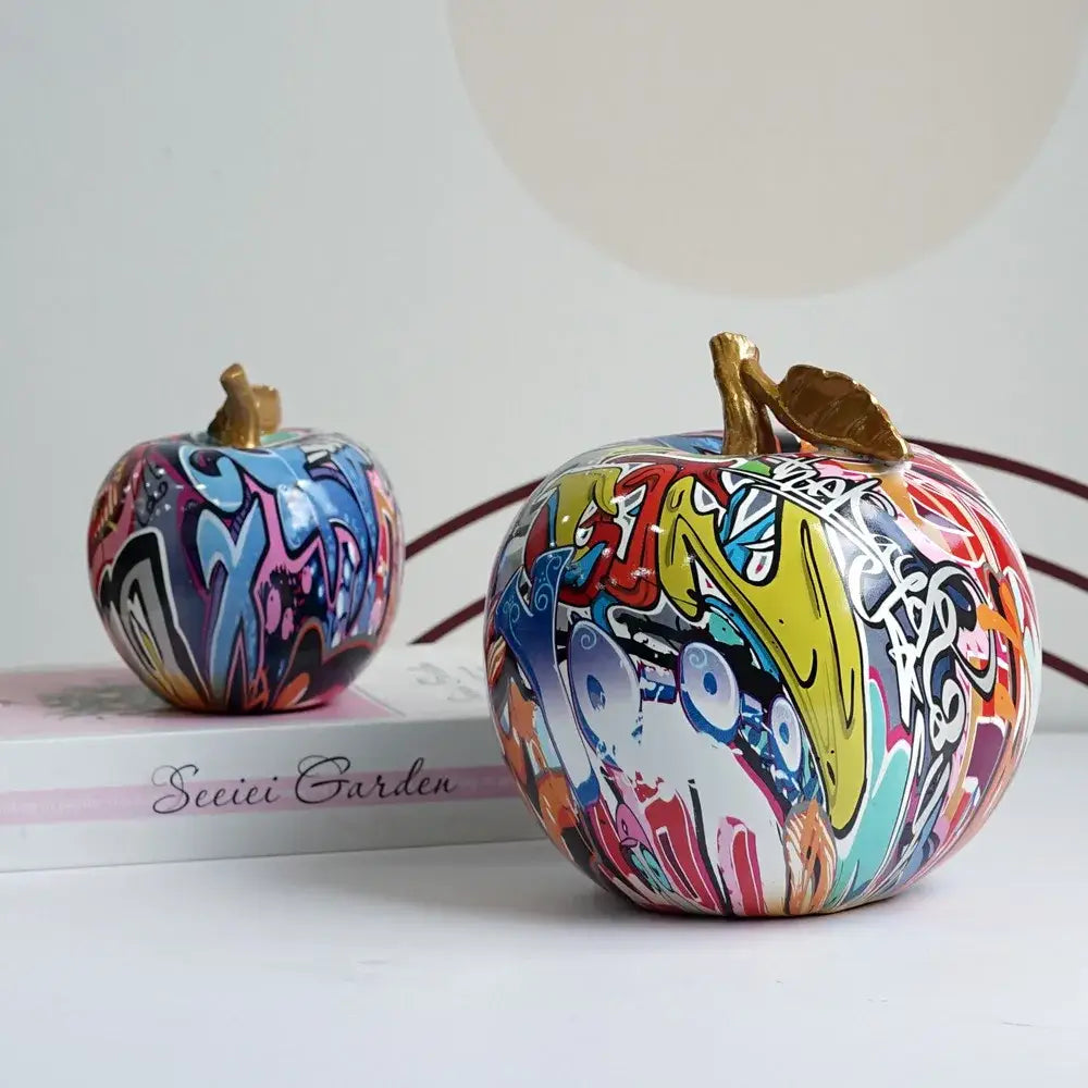 DecorBites apple sculpture resin ornament featuring vibrant graffiti-painted apples with gold-toned stems for modern decor