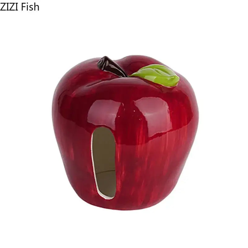 Glossy red DecorBites apple shape ceramic tissue box with green leaf stem and oval side opening for coffee table decor