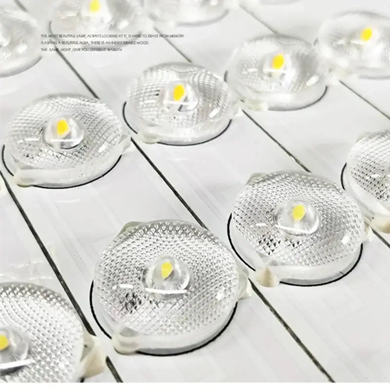 Clear circular led light modules with textured glass lenses and yellowish emitters in decorbites apple shape ceiling chandelier