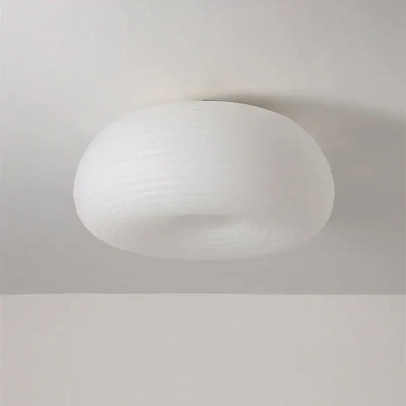 A sleek white frosted glass decorbites apple shape ceiling chandelier with a smooth rounded dome design for bedroom and kitchen