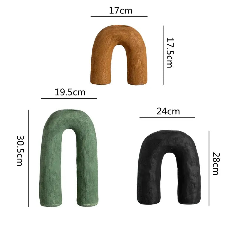 Three u-shaped decorbites arc ceramic vases in natural, moss green, and matte black finishes for home decor