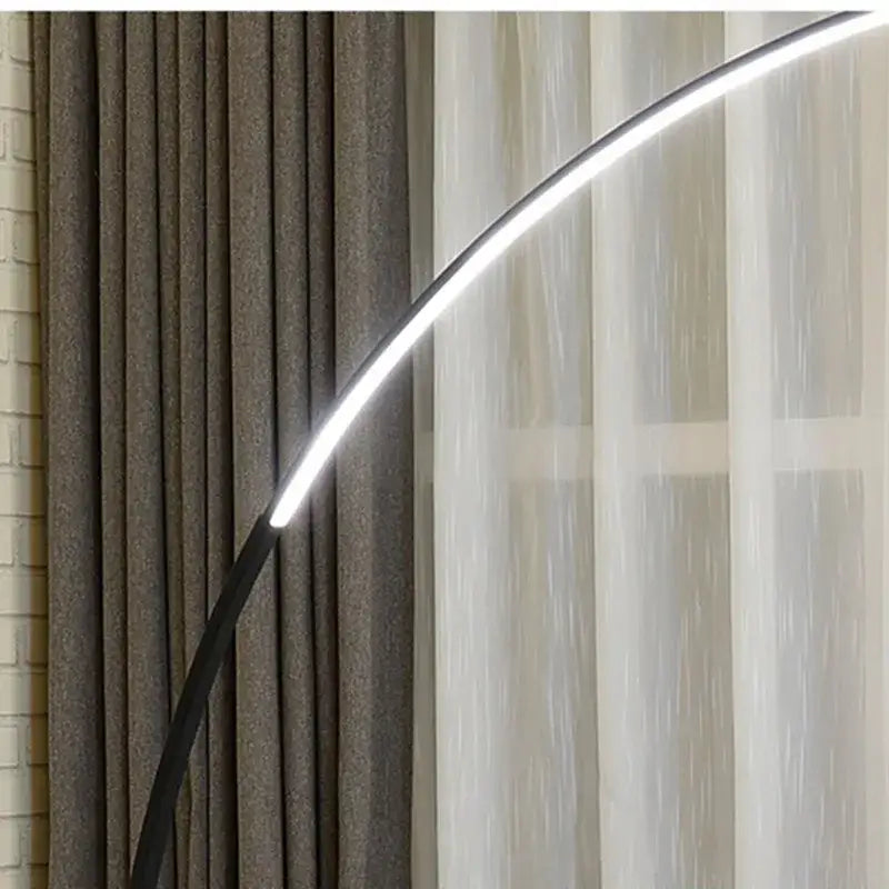 Modern black decorbites arc floor lamp with arched led light strip emitting bright white illumination for indoor use
