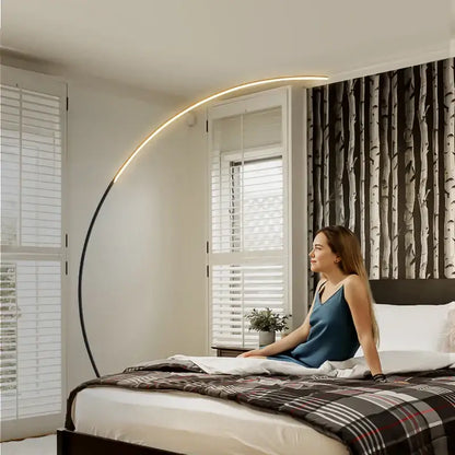 DecorBites arc floor lamp with curved black metal frame and warm LED strip for indoor dining and living room decor