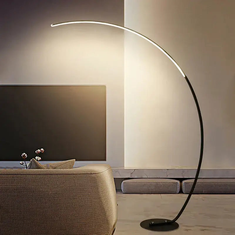 Modern curved DecorBites arc floor lamp with sleek black metal frame and integrated LED lighting for indoor decor