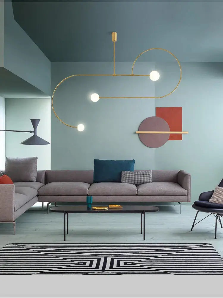 Gold-toned decorbites arc line chandelier with curved metallic arms and spherical bulbs for living dining room kitchens