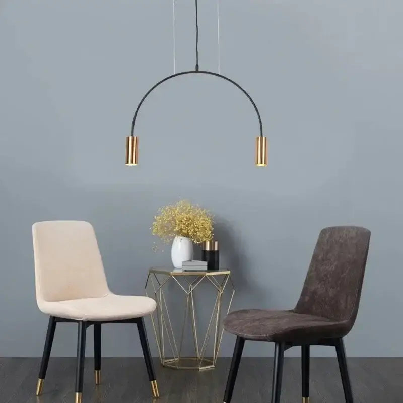 Modern DecorBites Arc pendant light with black curved frame and gold cylindrical fixtures for kitchen island lighting