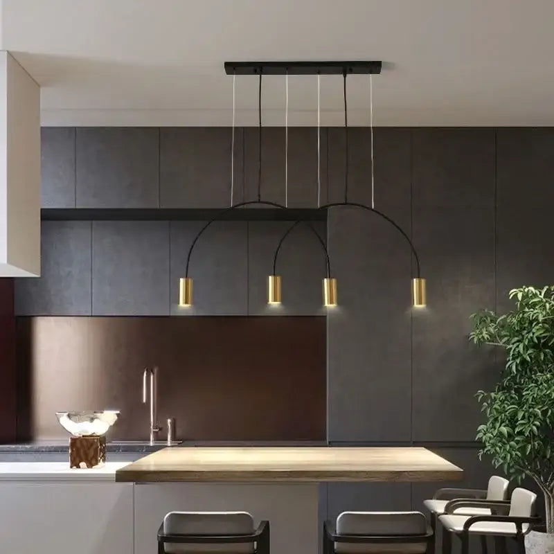 Modern black and gold DecorBites arc pendant light with curved arms and cylindrical bulbs for kitchen island lighting