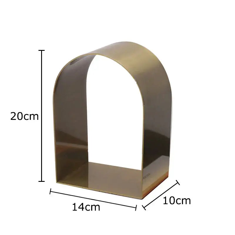 A sleek brass metal shelf with an arched minimalist design from decorbites arches geometry desk decoration collection