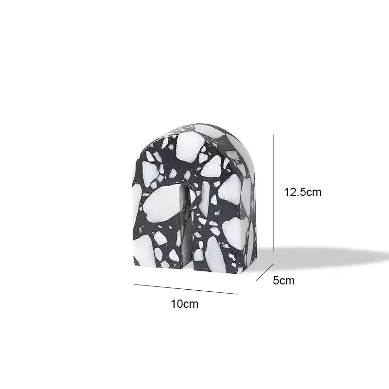 Black and white terrazzo sculpture in an arch shape with speckled stone texture decorbites archway terrazzo bookend