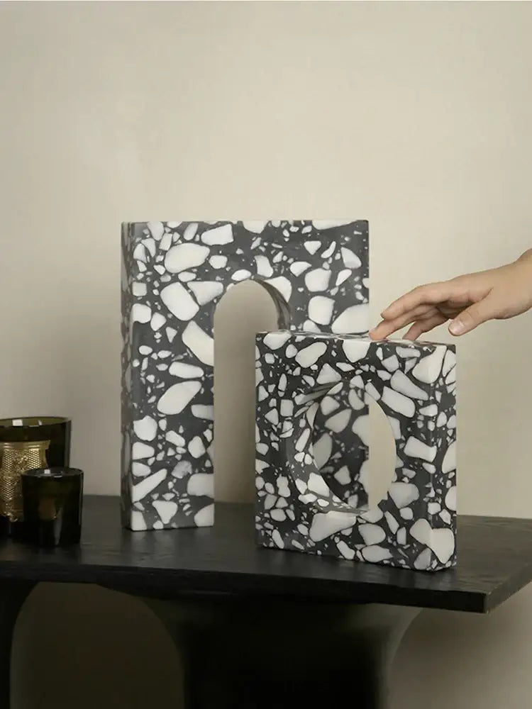 Black and white terrazzo sculpture bookends with speckled stone texture decorbites archway terrazzo for home decor
