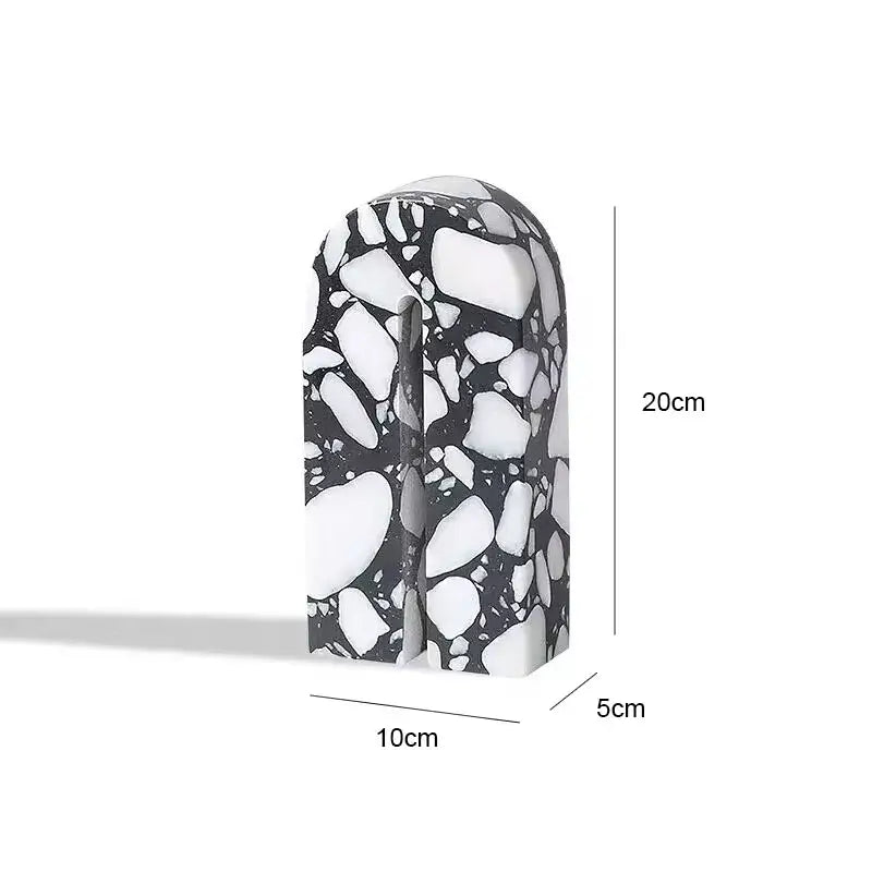 A sleek 20cm tall black and white terrazzo sculpture with a smooth arch design for decorbites archway terrazzo decor