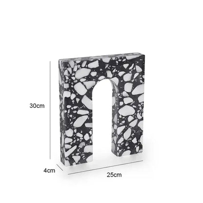 A sleek black and white terrazzo sculpture in a u shape 30cm tall from decorbites archway terrazzo collection
