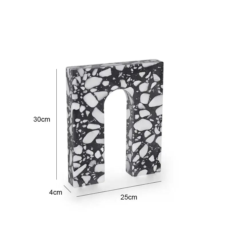 A sleek black and white terrazzo sculpture in a u shape 30cm tall from decorbites archway terrazzo collection