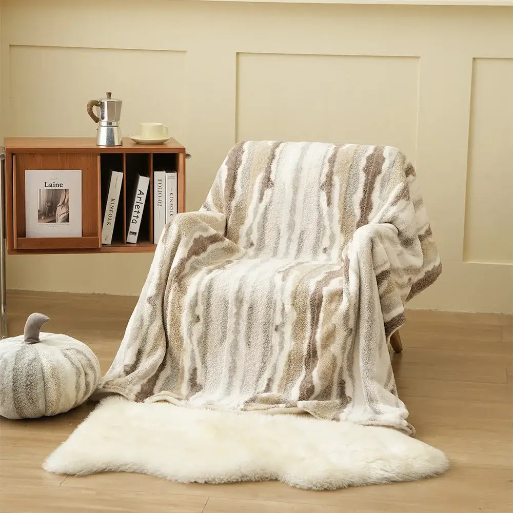 A cozy decorbites arctic velvet faux rabbit throw blanket with soft textured surface and beige cream taupe stripes