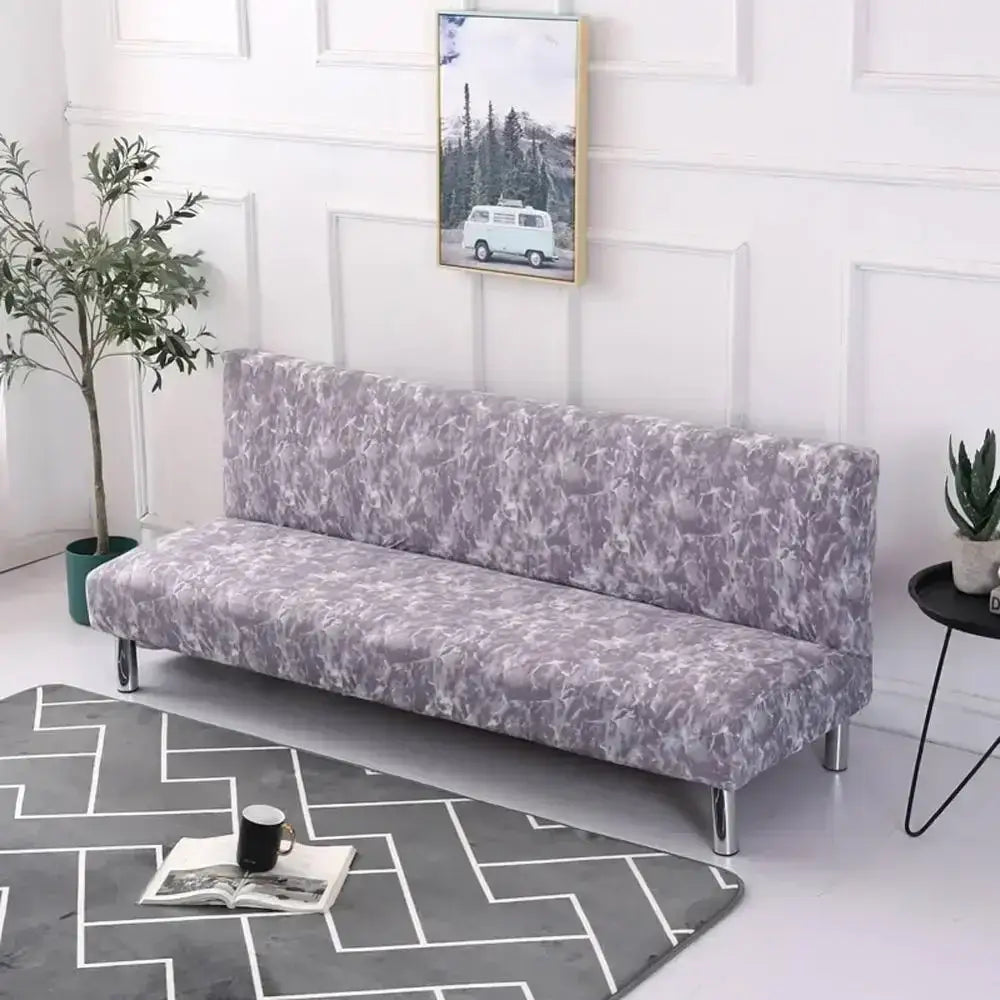 A lavender and gray abstract patterned decorbites armless futon sofa cover snugly fits a modern futon with chrome legs